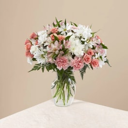 Pink and white mixed bouquet in a clear glass vase