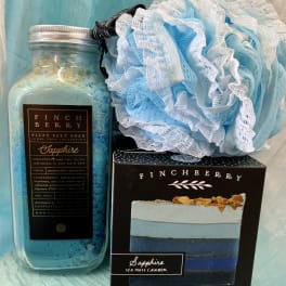 Blue bath soak jar with a matching soap box and bath pouf