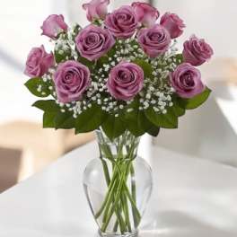 Pink roses arranged in a clear glass vase
