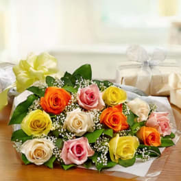 Bouquet of multicolored roses wrapped in paper