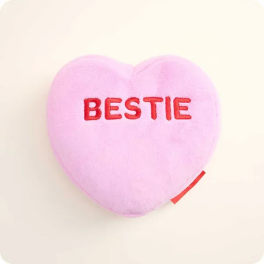 Pink heart-shaped plush with the word BESTIE embroidered on it