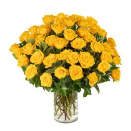 Large arrangement of yellow roses in a clear glass vase