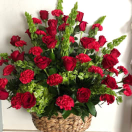 Basket arrangement of red roses and carnations
