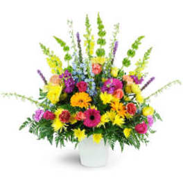 Colorful mixed flower arrangement in a white vase