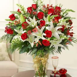 Bouquet of red roses and white lilies in a clear glass vase