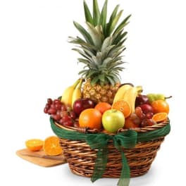 Fruit basket with pineapple, bananas, grapes, oranges, and apples