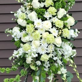 Tall white and green floral standing spray on an easel