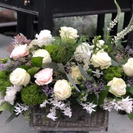 Mixed white and blush roses arranged in a rustic wooden box