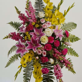 Tall standing floral spray with pink, yellow, and white flowers