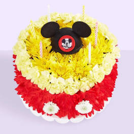 Mickey Mouse-themed floral cake with striped candles
