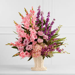 Pink and purple floral arrangement in a textured vase