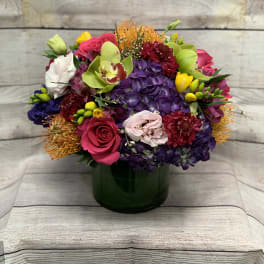 Colorful mixed bouquet in a dark glass vase