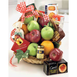 Gift basket with fruit, crackers, cheese, and sausage in a wicker basket