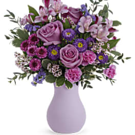 Lavender and pink mixed bouquet in a light purple vase