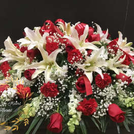 Large red and white floral arrangement with lilies, roses, and carnations