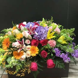 Large mixed flower arrangement with roses, lilies, hydrangeas, and gerbera daisies