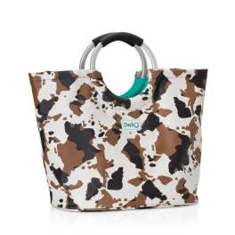 Cow-print tote bag with silver handles and a black grip