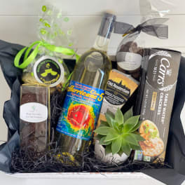 Gift basket with wine, chocolates, crackers, cheese, and a small succulent
