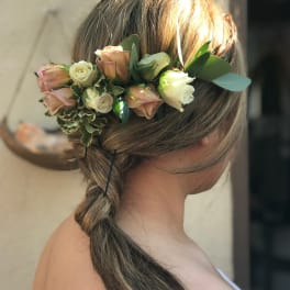Woman wearing a floral crown of blush and cream roses