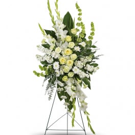 Tall white and pale yellow floral standing spray on an easel