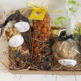 Gift basket with wrapped snacks and cookies tied with ribbons