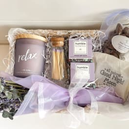 Gift basket with lavender candle, bath items, chocolates, and dried lavender bouquet