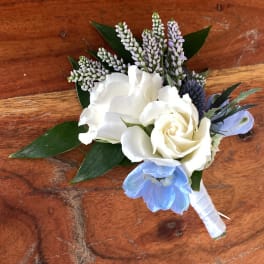 Small white and blue floral boutonniere with ribbon wrap
