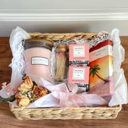 Gift basket with a candle, bath bombs, matches, and dried roses
