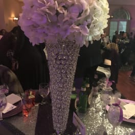 Tall white and lavender floral centerpiece in a crystal vase