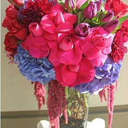 Bright mixed bouquet of roses, tulips, and hydrangeas in a vase
