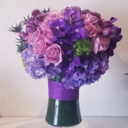 Purple and pink bouquet in a glass vase