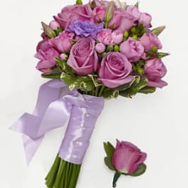 Pink and lavender rose bouquet with a ribbon-wrapped handle and matching boutonniere