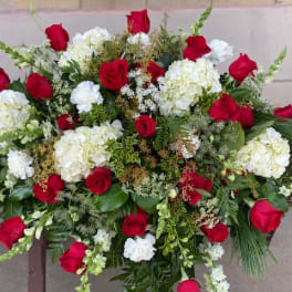 Large red and white floral arrangement with roses and hydrangeas