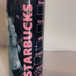 Black Starbucks tumbler with pink lettering and a mermaid graphic