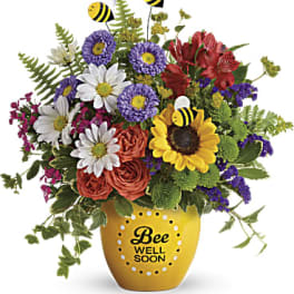 Mixed bouquet in a yellow vase with bee decorations and "Bee Well Soon" text