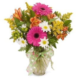 Mixed bouquet with pink gerberas, daisies, and orange alstroemeria in a glass vase