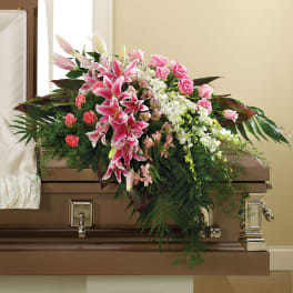 Pink lilies and roses arranged on a casket