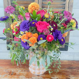 Bright mixed bouquet in a textured vase
