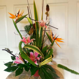 Tall tropical arrangement with pink lilies and orange bird-of-paradise flowers