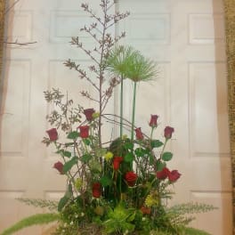 Tall basket arrangement with red roses and airy greenery