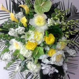 Yellow and white floral arrangement with anthuriums and roses