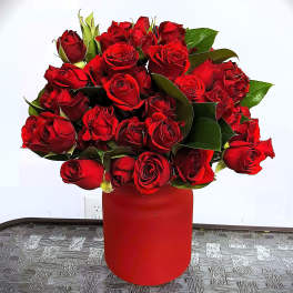 Red rose bouquet in a red cylindrical vase