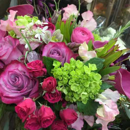 Bouquet of pink and purple roses with green hydrangea and pale sweet peas