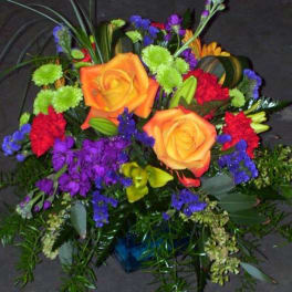 Colorful bouquet with orange roses, purple flowers, and green accents