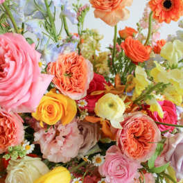 Colorful bouquet of roses, ranunculus, and mixed blooms