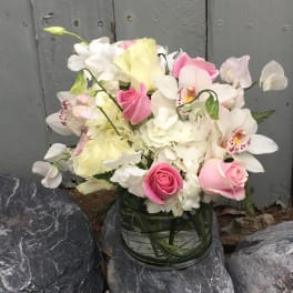 Pink and white bouquet in a clear glass vase