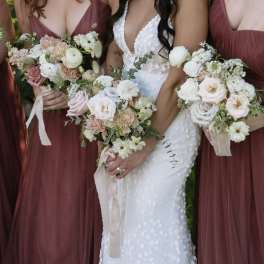 Bride and bridesmaids holding pastel wedding bouquets
