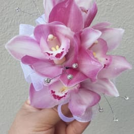 Small pink orchid corsage with ribbon and silver bead accents