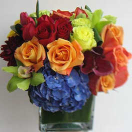 Colorful bouquet of roses and hydrangeas in a clear glass vase