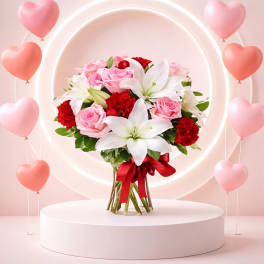 Pink and red bouquet with white lilies and heart balloons
